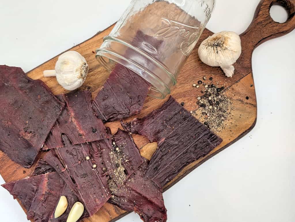 Retail beef jerky display featuring cracked pepper and garlic flavor made in Wisconsin