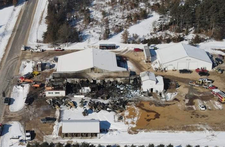 Aerial view of fire damage and rebuilding activity at the Wisconsin River Meats facility in Mauston, Wisconsin.