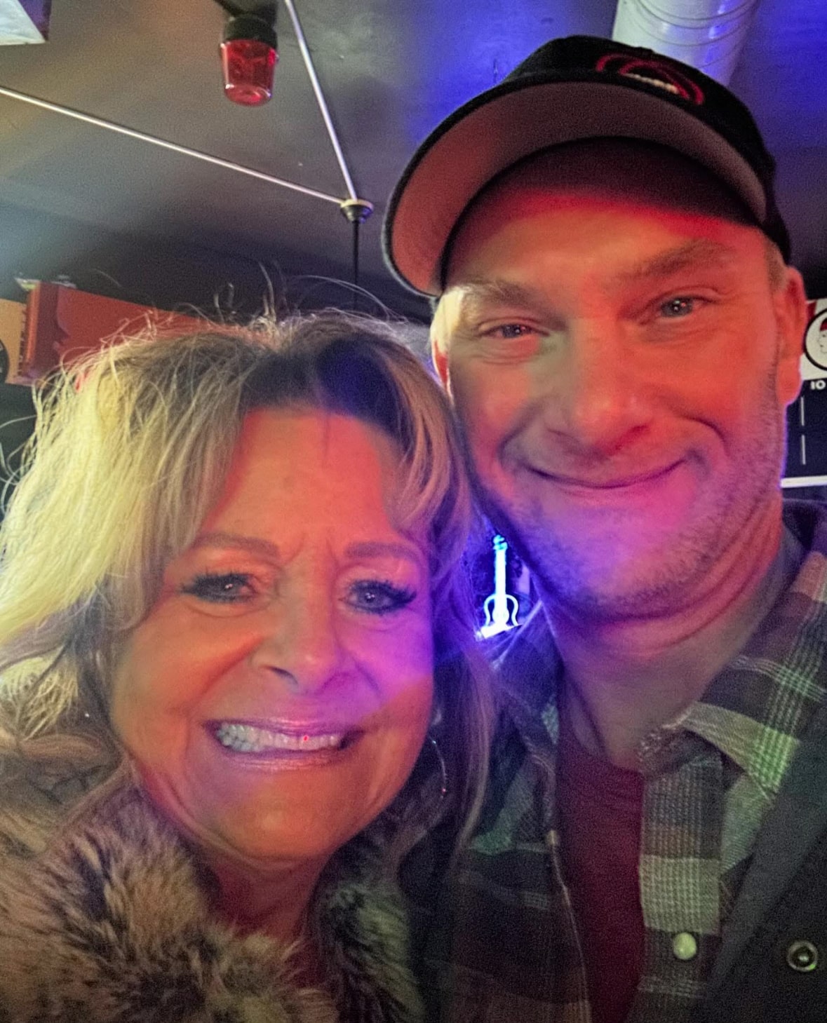 David Mauer, Vice President of Wisconsin River Meats, smiling for a photo with a woman at a community event.