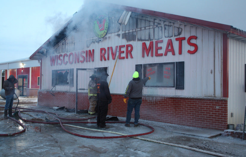 Firefighters and emergency crews responding to smoke and fire damage at the Wisconsin River Meats facility in Mauston, Wisconsin.